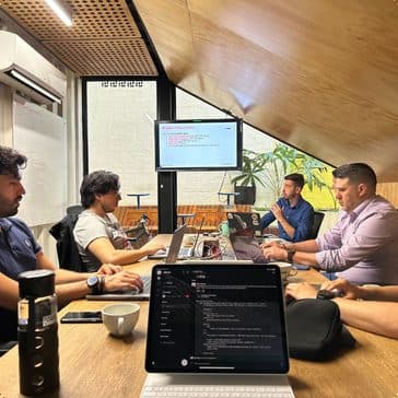 Engineers working together at a shared table during a build session
